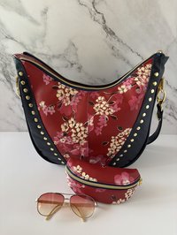 Curved semi-slouchy handbag with matching eyewear/sunglass case, in a floral pattern in cream, pink, and maroon tones, with a rich solid navy